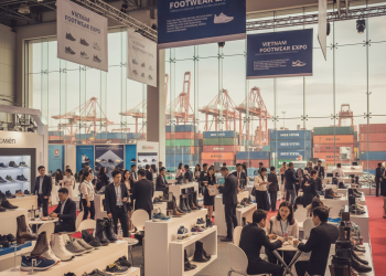 Vietnamese footwear exhibition with suppliers and visitors.