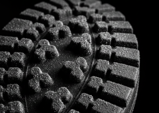Close-up of severe white blooming defect on black rubber footwear outsole