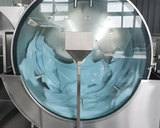 Steel rotating wooden tanning drum filled with blue liquor and floating cattle hides