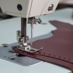 Footwear stitching thread interaction with needle and rotary hook