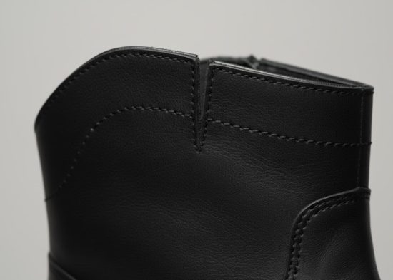 Boot top-line cut-out pattern design for improved fit in footwear manufacturing