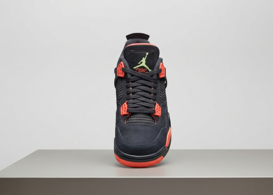 Studio product photograph of the Air Jordan 4 GS Infrared highlighting mango eyelet accents.