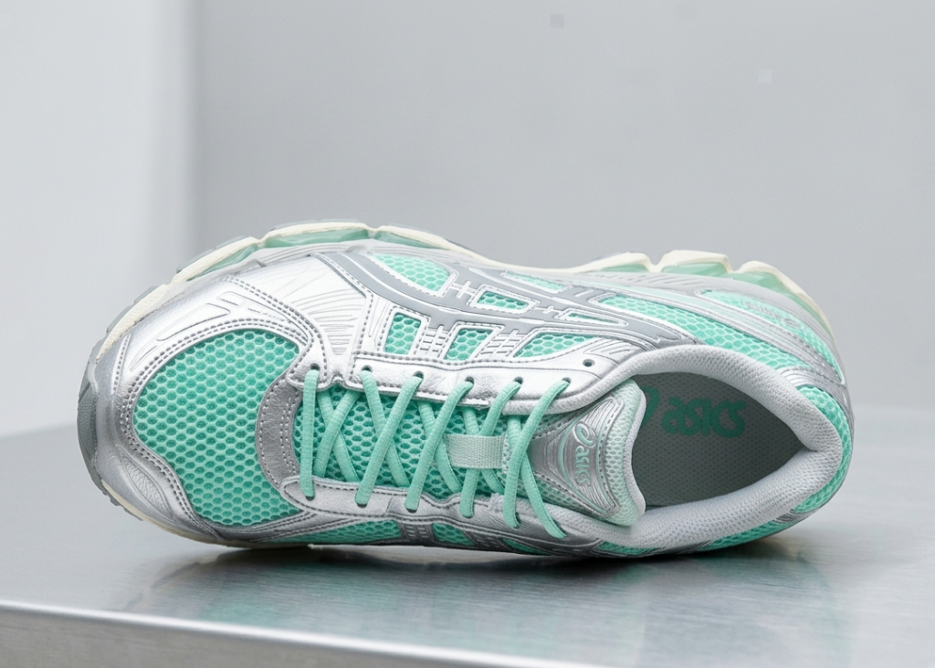 High-fashion product alignment shot of the ASICS GEL-Kayano 12 in mint green and silver.