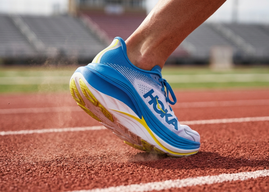 Close-up of the thick oversized midsole structure on the Hoka Skyward X2 on an outdoor track.