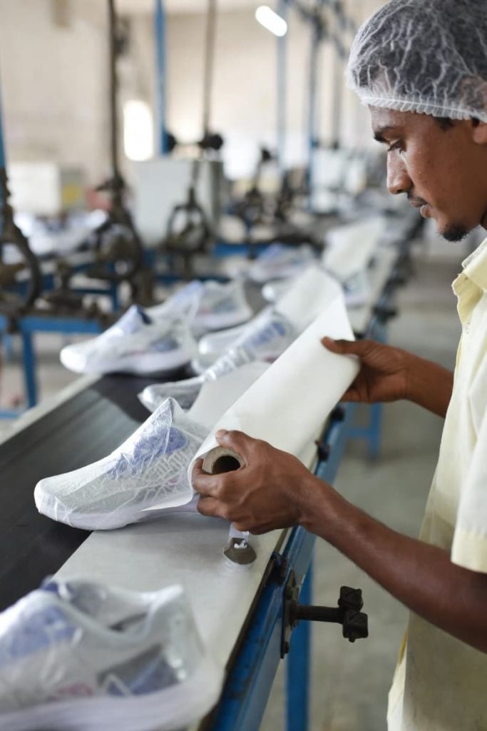 Tissue paper wrapping process in footwear manufacturing.