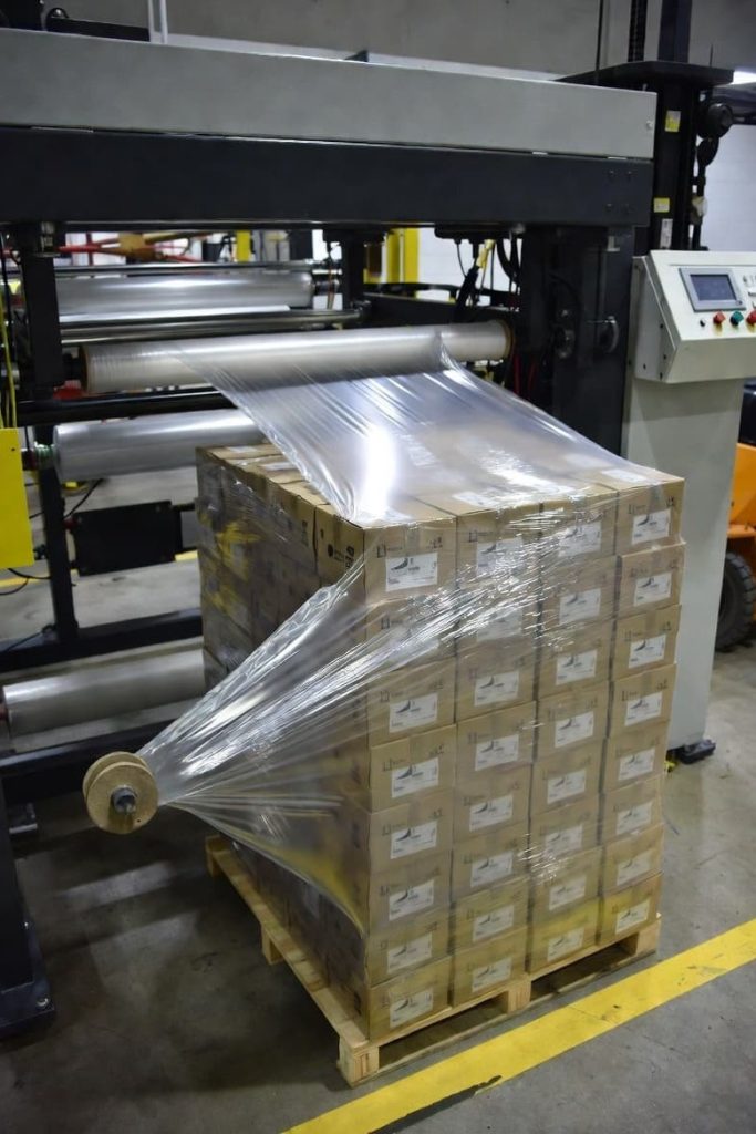 Stretch wrapping footwear cartons