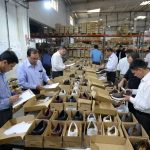 Final AQL Audit inspection in a footwear manufacturing factory before shipment approval.