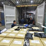Container stuffing operation in a footwear manufacturing factory.