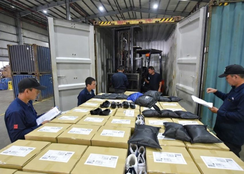 Container stuffing operation in a footwear manufacturing factory.