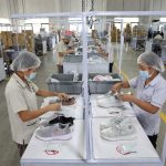 Footwear wrapping process using tissue paper, silica gel, and anti-mold protection.