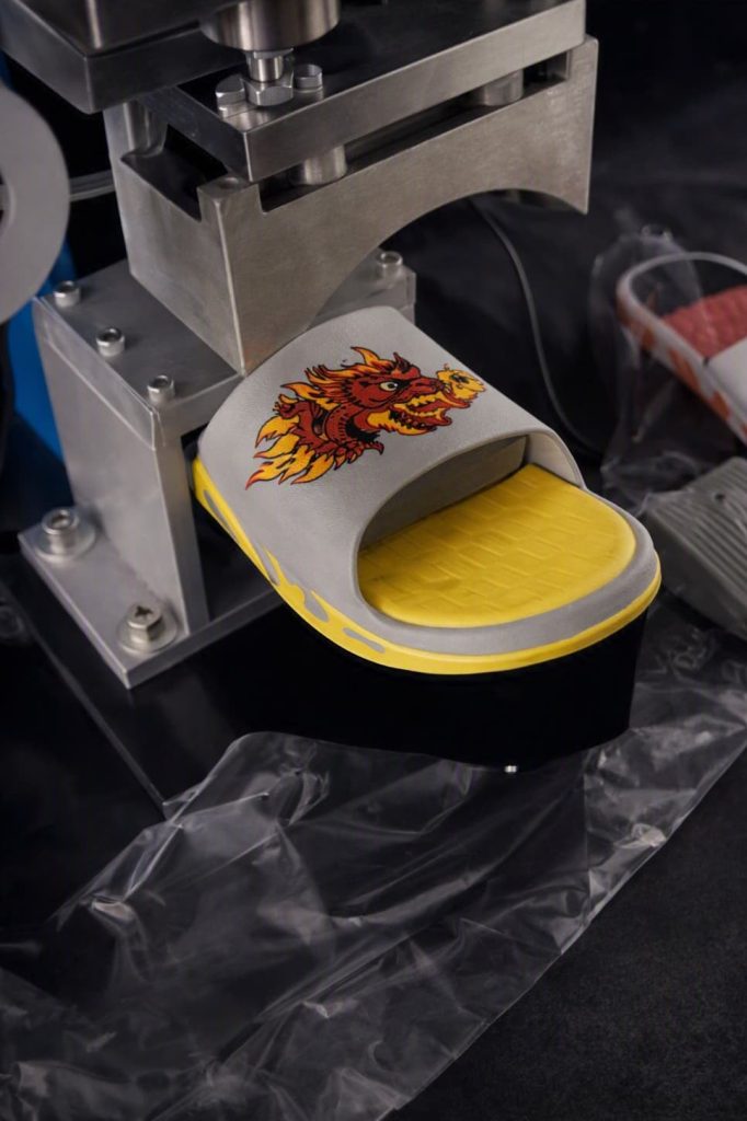 Transfer foil operation on premium footwear outsole using industrial heat press.